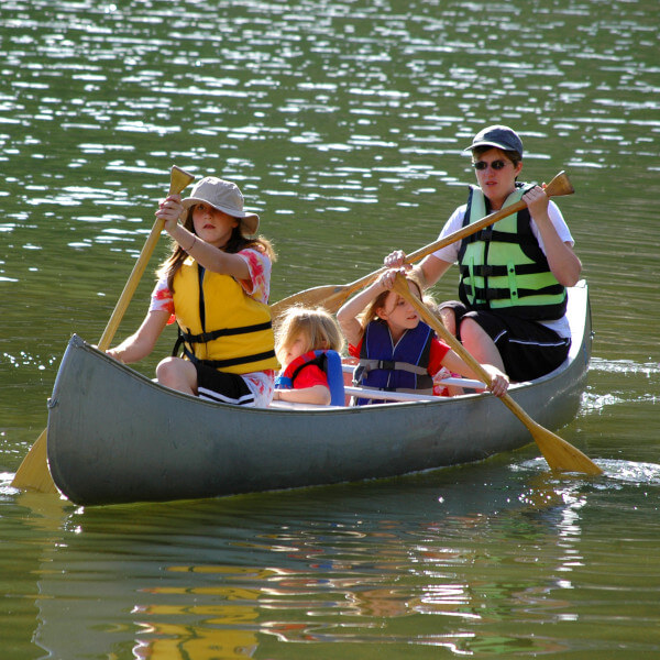 family paddling a canoe