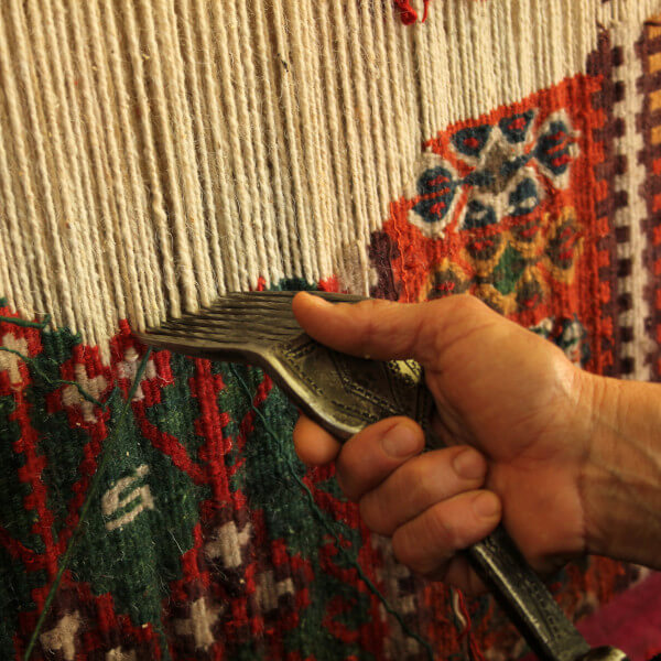 hand-weaving a rug or carpet