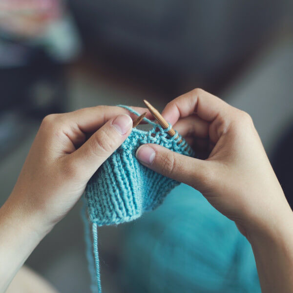 knitting with blue yarn